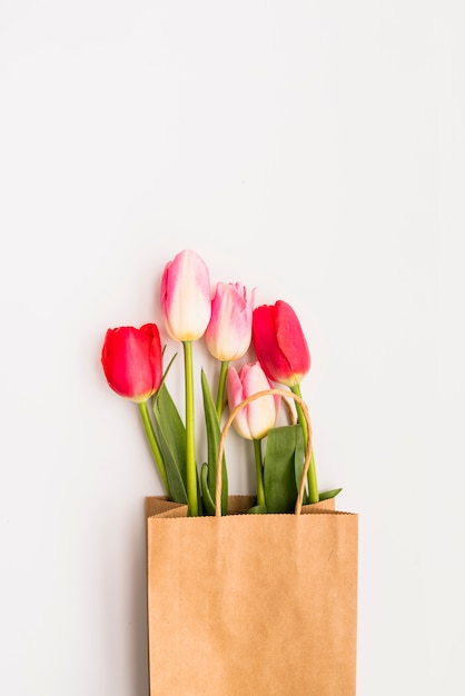 Bright tulip bouquet in paper bag
