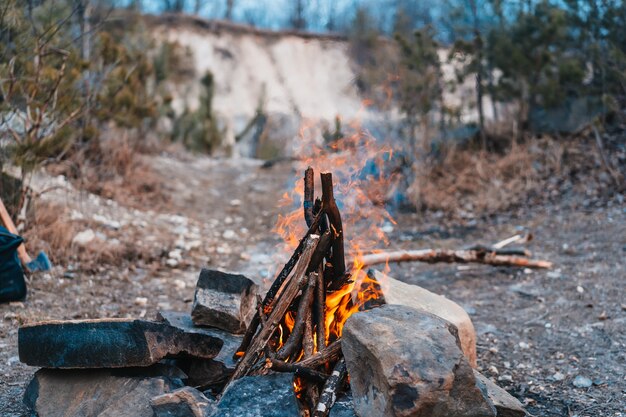 Bright yellow bonfire on gray sand