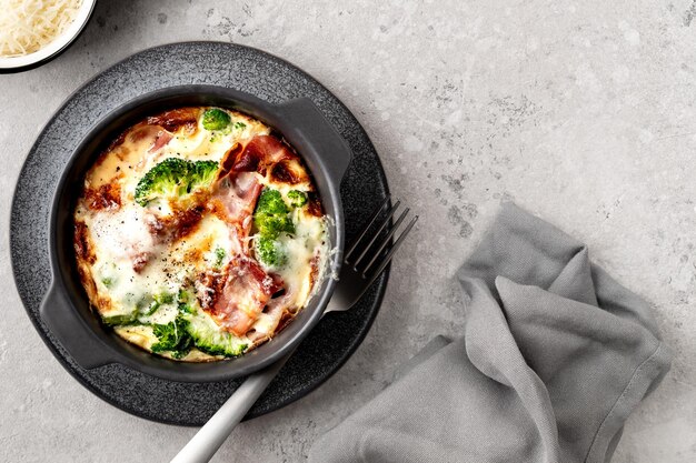 Broccoli bacon Cheese Bake on a gray stone background