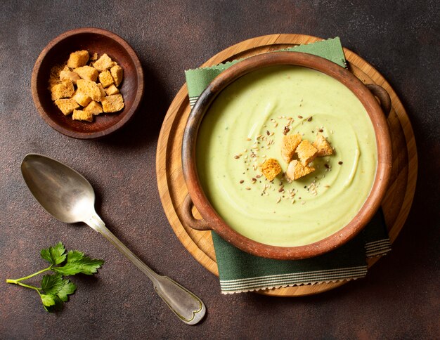 Broccoli soup winter food with croutons top view