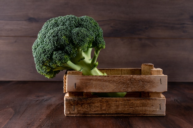 Broccoli in a wooden box fresh vegetable on wooden surface