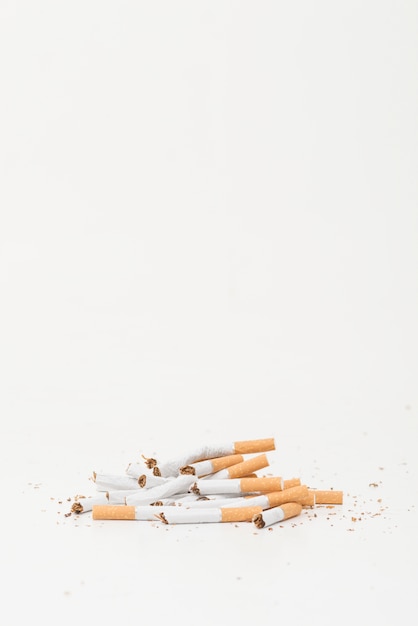 Broken cigarettes on white background with copy space for writing text