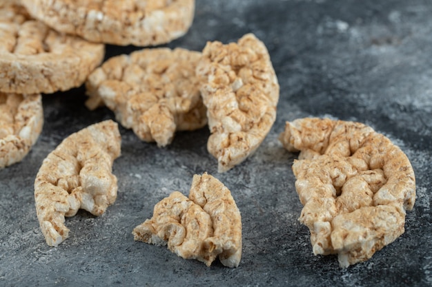 Broken crispbread slices on marble surface