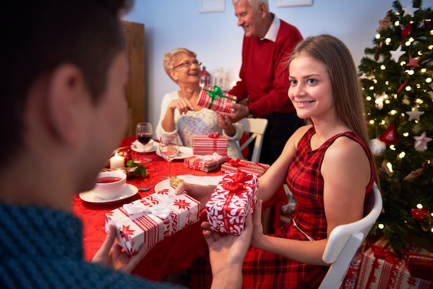 Brother and sister exchanging christmas gifts