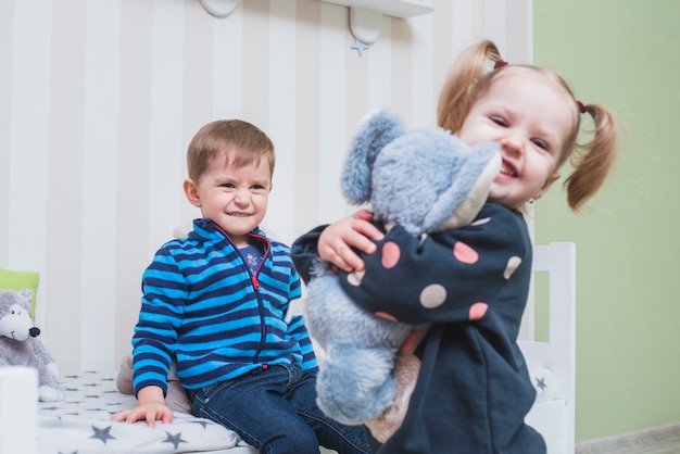 Brother and sister playing in children room