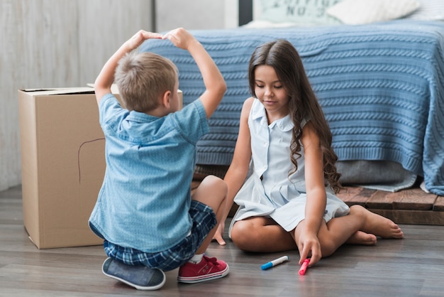 Brother and sister playing together in bedroom