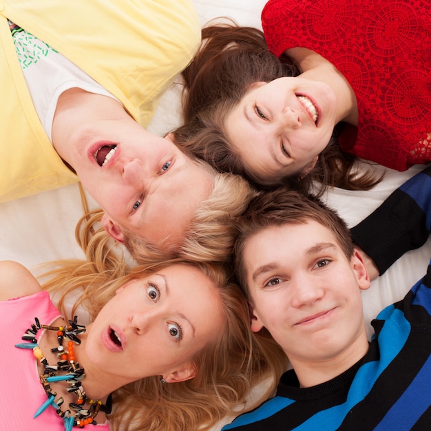 Brothers and sister lying on a floor