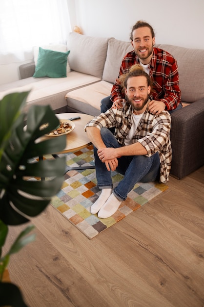 Free photo brothers sitting on couch high angle