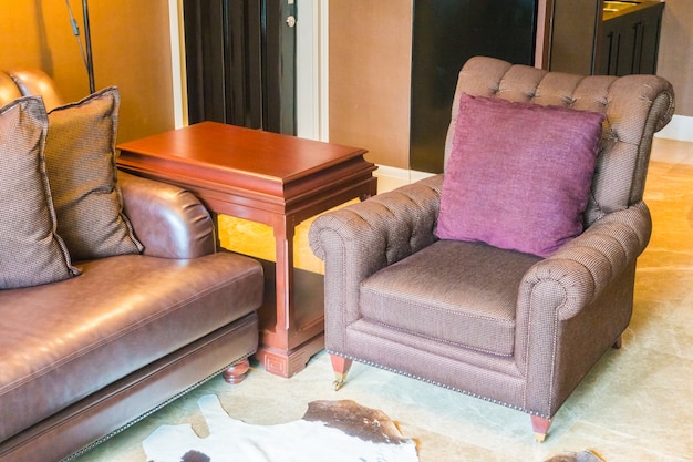 Brown armchair with purple pillow
