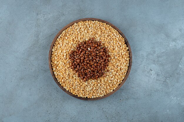 Brown beans and peas on a wooden platter. High quality photo