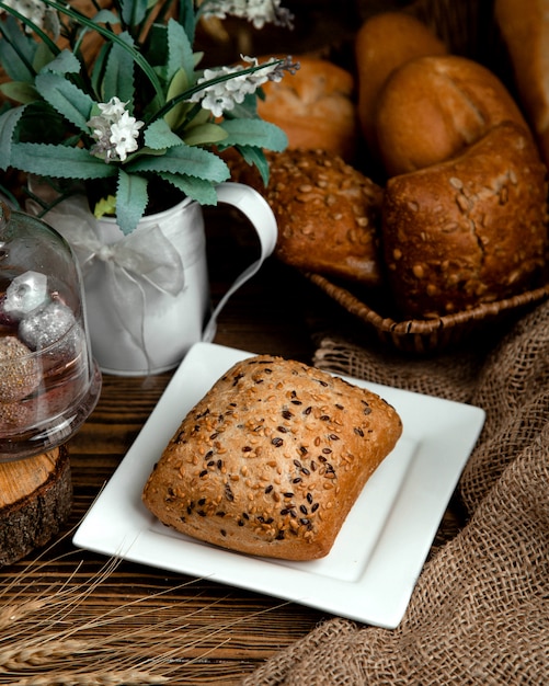 Brown bread bun with sesame and flax seeds on top