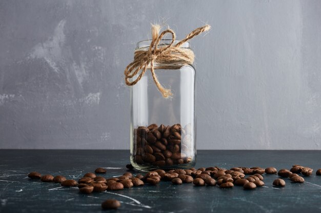 Free photo brown coffee beans in a glass jar.