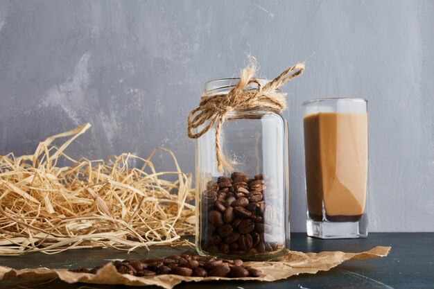 Brown coffee beans in a glass jar.