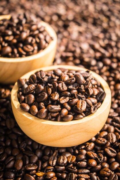 Brown coffee beans in wood bowl