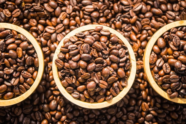 Brown coffee beans in wood bowl