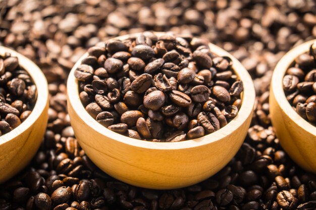 Brown coffee beans in wood bowl