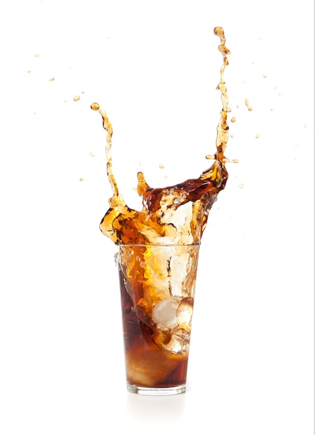 Brown drink falling in ice