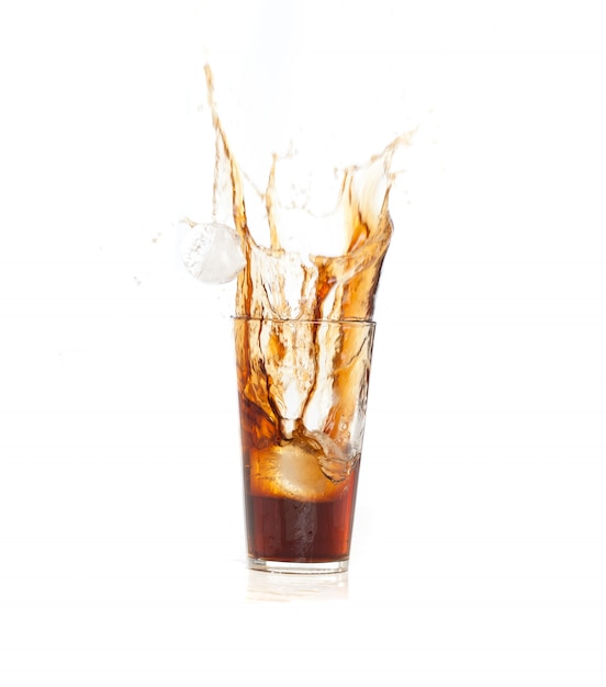 Brown drink falling in ice