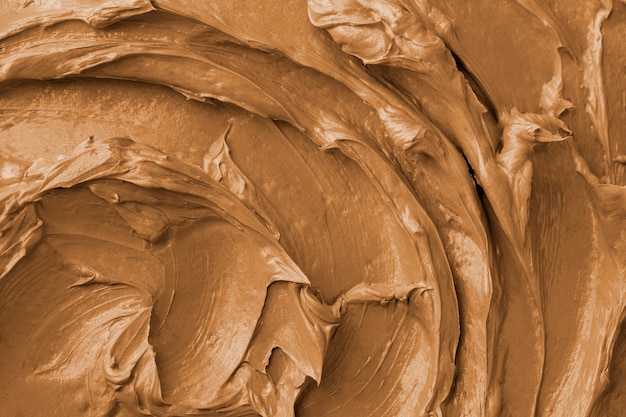 Free photo brown frosting texture background close-up