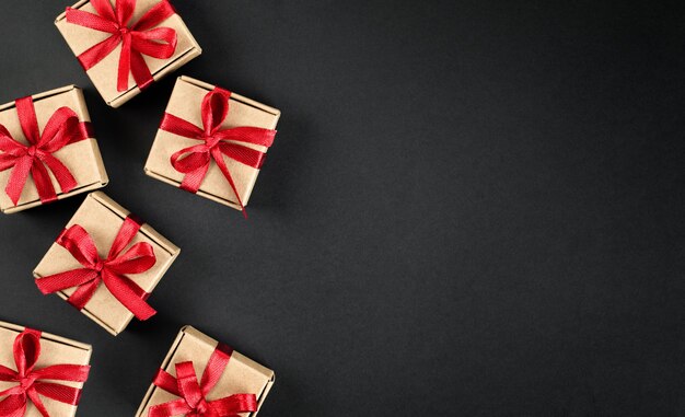 Brown gift boxes with red bows on dark background