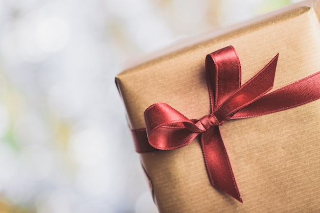 Brown gift with a dark red tie