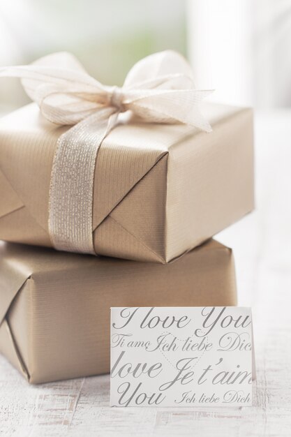 Brown gifts with a white tie and a note