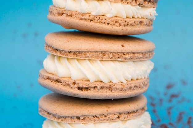 Free photo brown macaroons with whipped cream