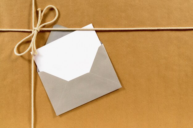 Brown paper parcel with envelope and message card