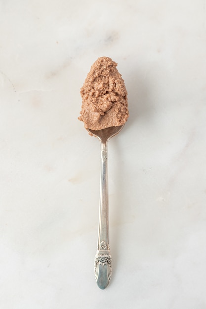 Brown powder on stainless steel spoon