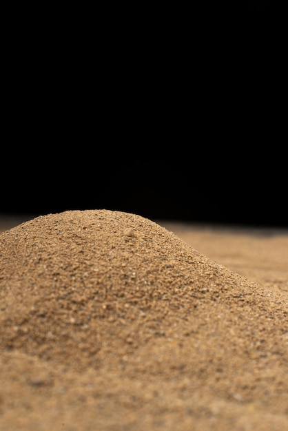 Brown sand on black wall