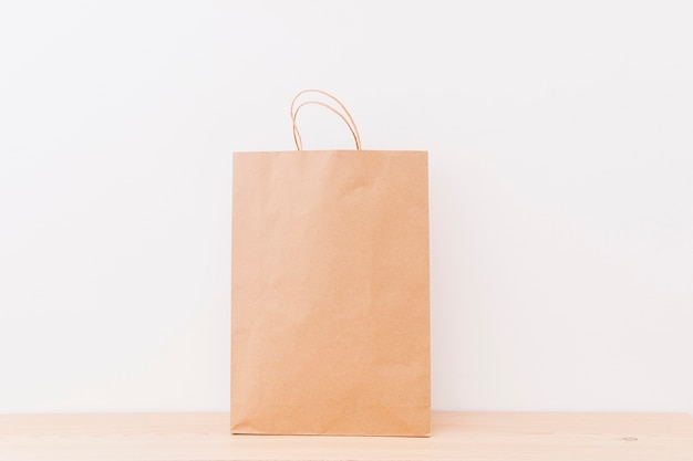Brown shopping bag on wooden surface