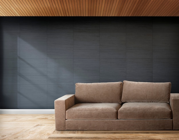 Коричневый диван в комнате с серыми стенами