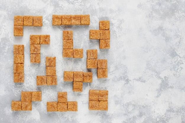 Brown sugar cubes on concrete ,top view