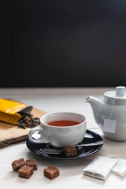 Brown sugar near cup of tea