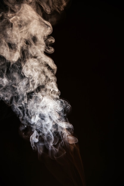 Brown wavy smoke on black background