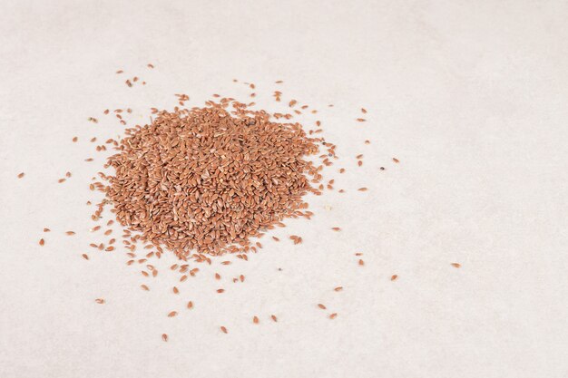 Brown wheat grains isolated on concrete.