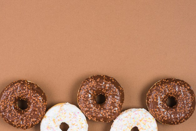 Brown and white doughnuts with sprinkles