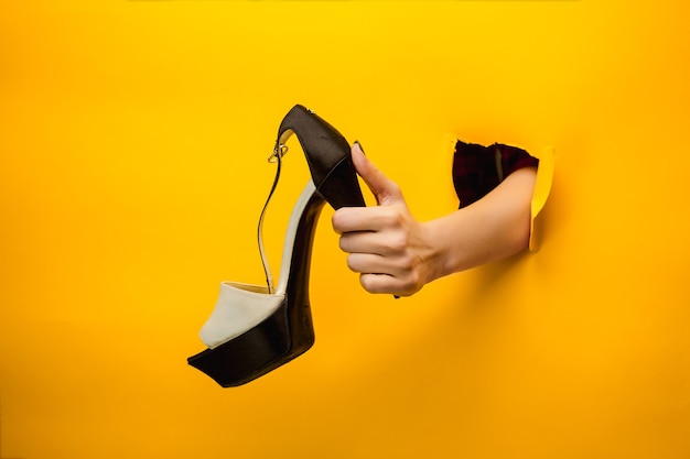 Brown woman shoe on hand isolated