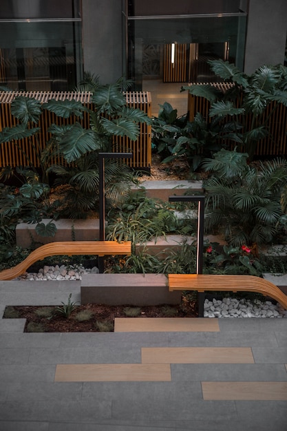 Brown wooden bench near green plants