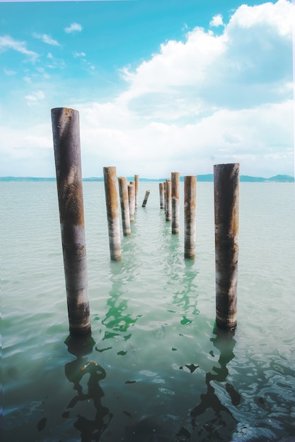 Brown wooden poles on body of water during daytime