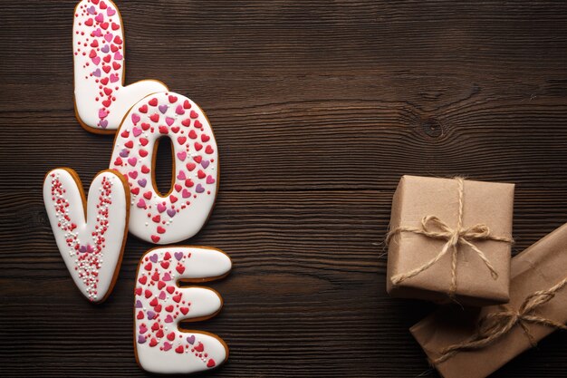 Brown wooden table with the word "love" and brown gifts