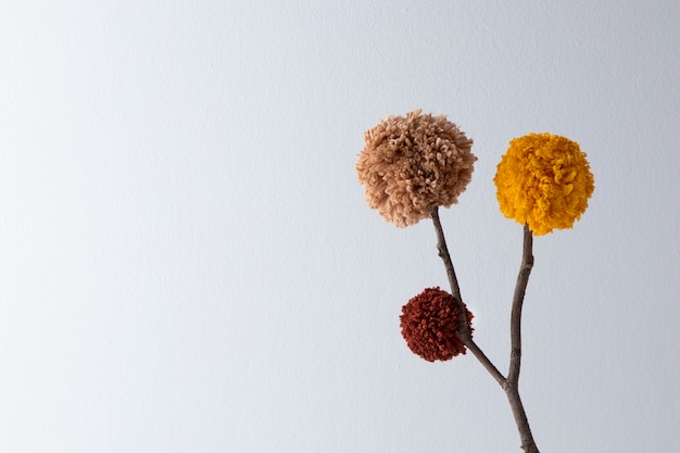 Brown and yellow pom poms with copy space