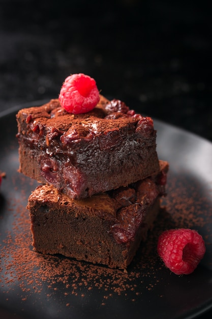 Brownie with raspberries and cocoa powder