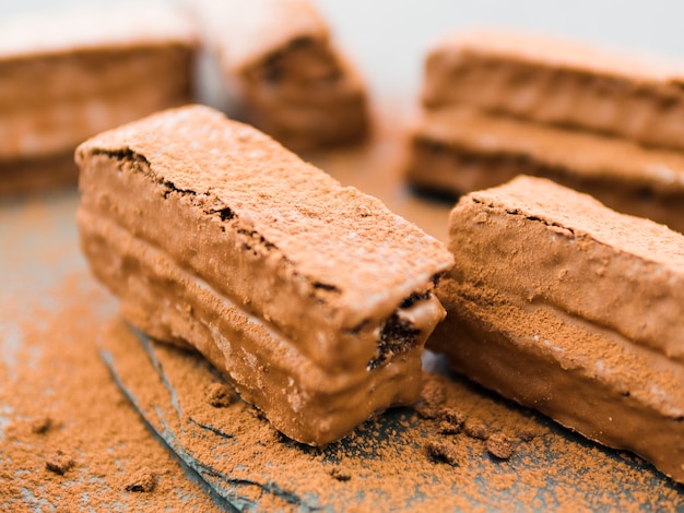 Brownies coated with chocolate and cocoa powder