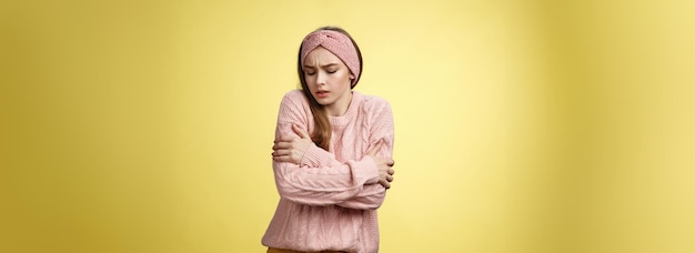 Brr girl freezing turnon heater portrait of timid cute woman wearing knitted sweater trembling from