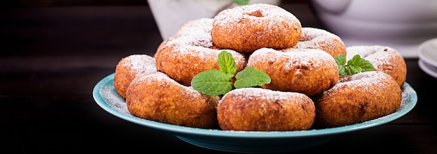 Brunch or lunch. Homemade donuts sprinkled with powdered sugar.