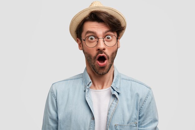 Brunet man wearing hat and denim shirt