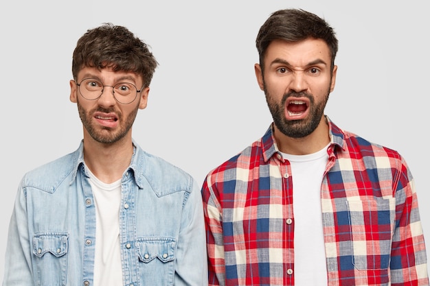 Brunet men wearing shirts and posing