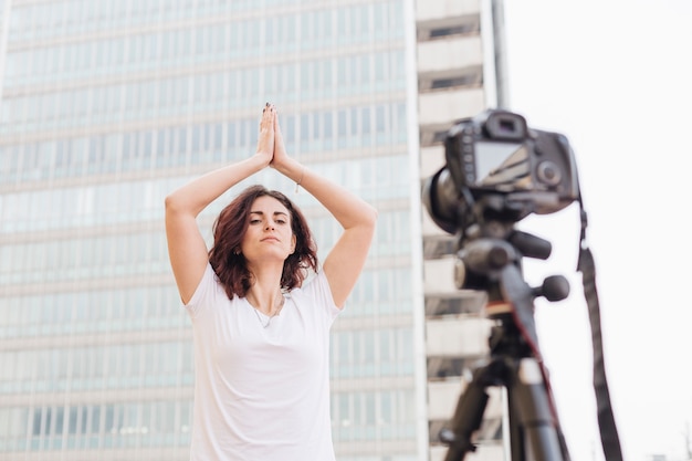 Brunette blogger recording yoga routine