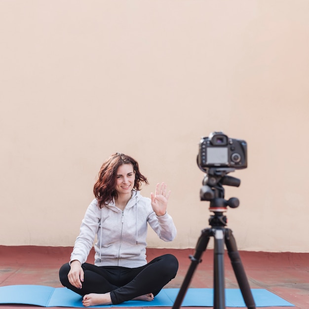 Brunette blogger recording yoga routine